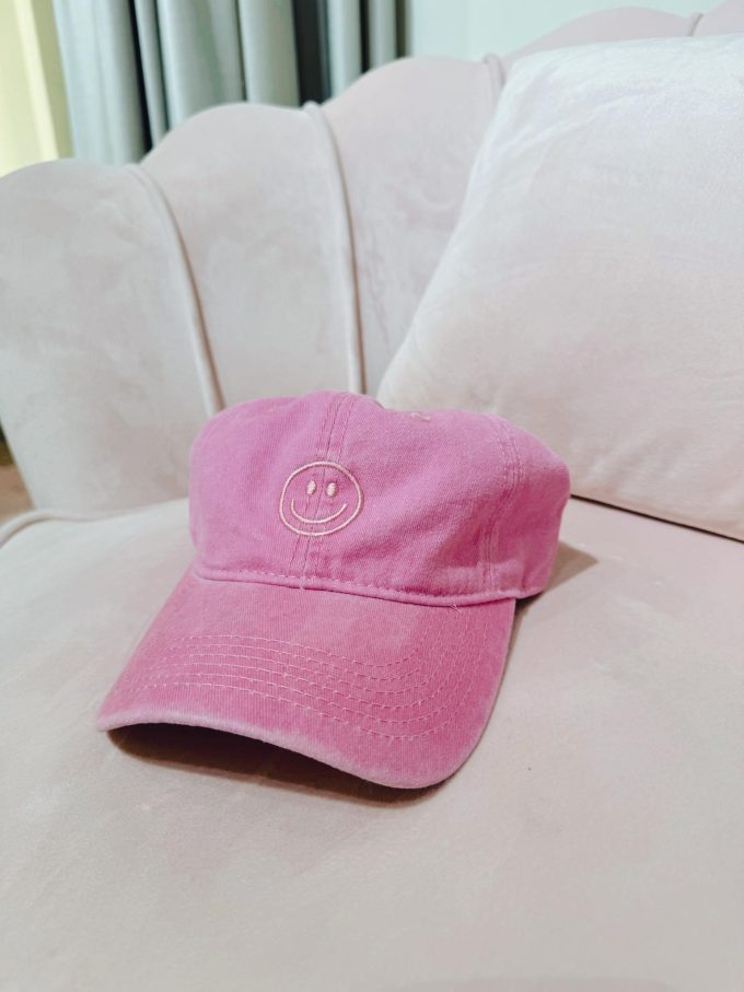 Pink smiley cap.