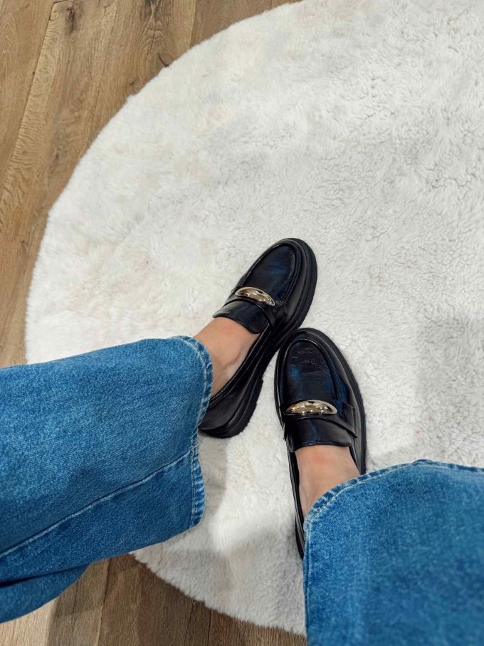 Black mocassin with golden detail.